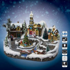 Village de noël avec église, sapin de noël et traineau